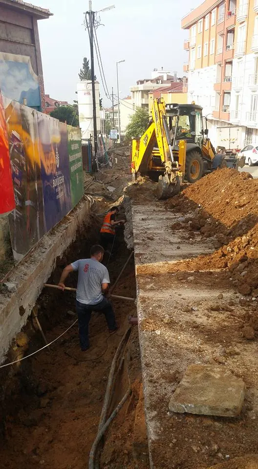 Duvar kenarında kazılmış kanalda altyapı çalışması